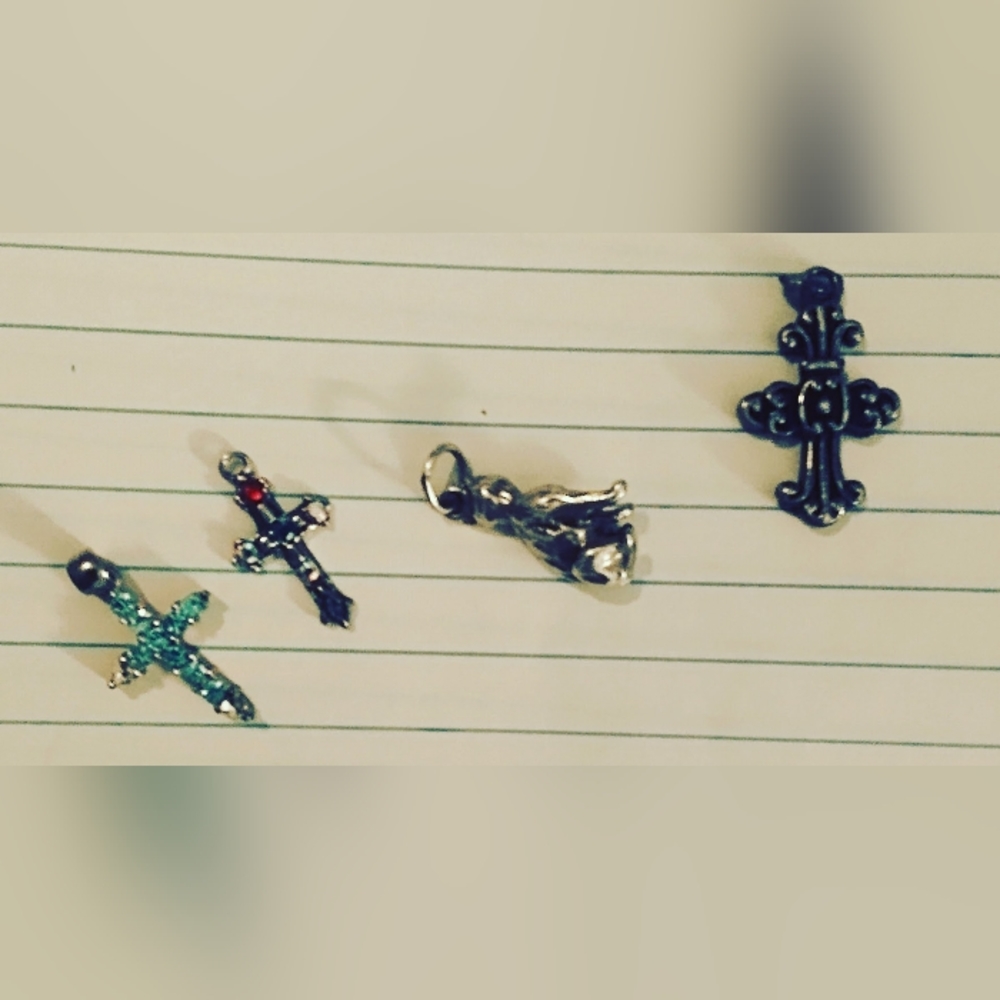 Four miniature cross charms
